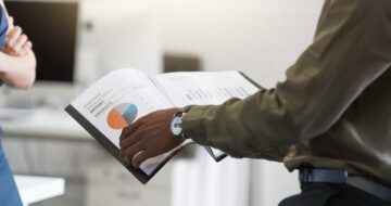 afro-american-mans-hands-holding-document-office_171337-7429